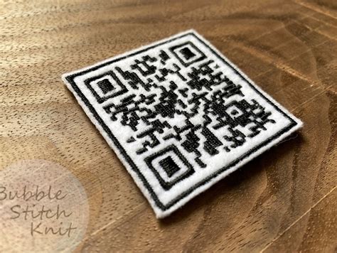 This is a rick astley face. . Rick astley qr code patch